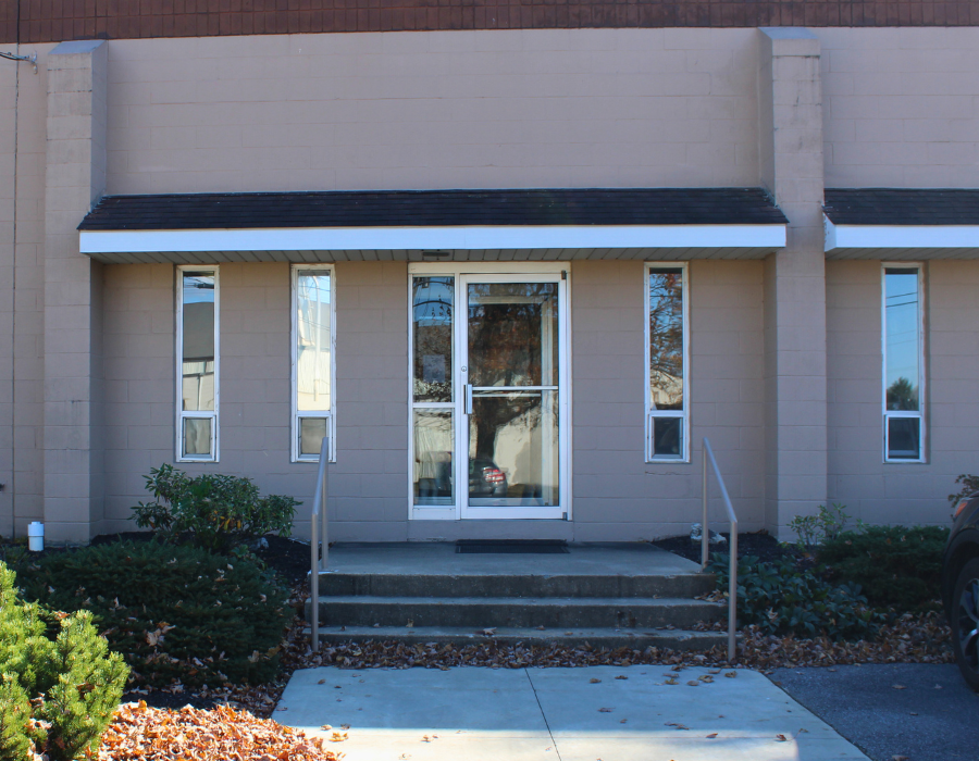 Front door view of a tan building