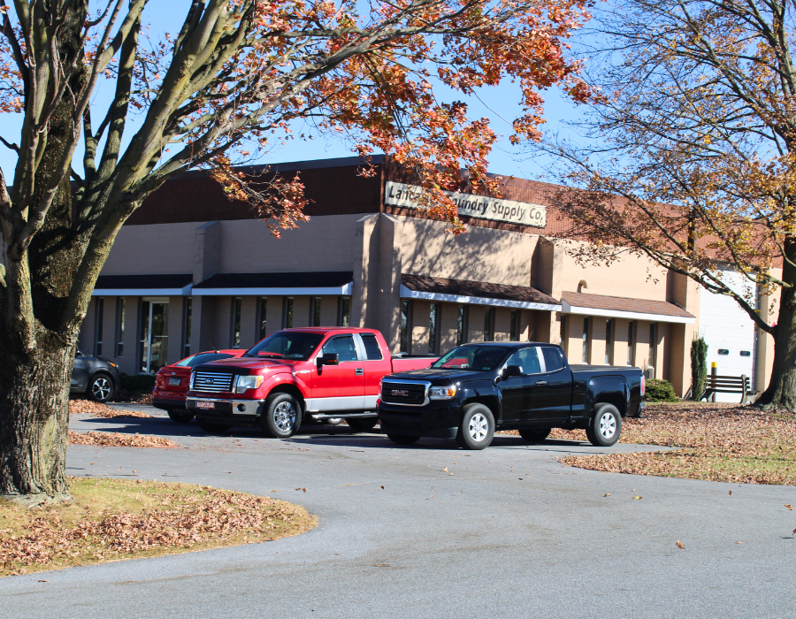 Cars and trucks parked outside Lancaster Foundry Supply Company building